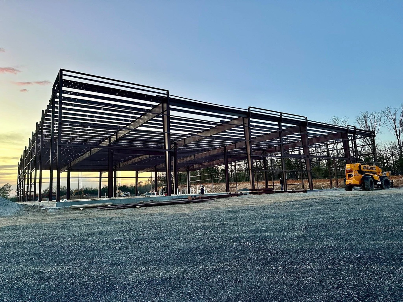 Large clear-span steel frame at sunset